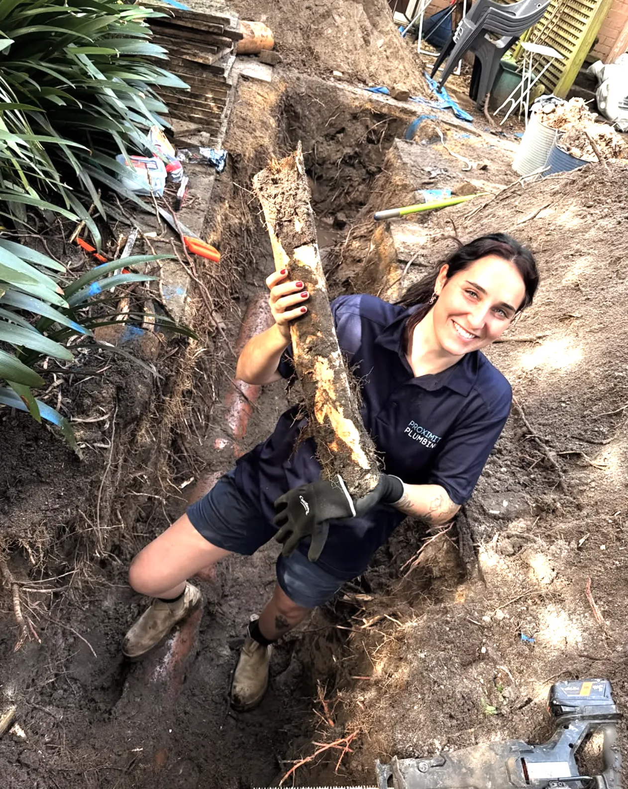 Clearing roots from a garden drain trench