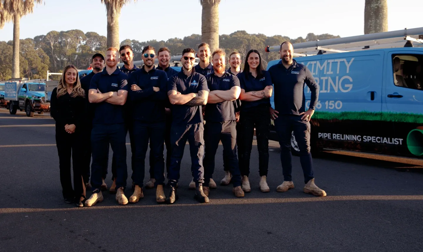 Plumbing team standing with the van line-up